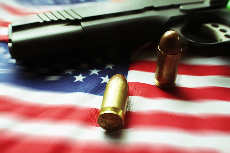pistol and ammunition on American flag